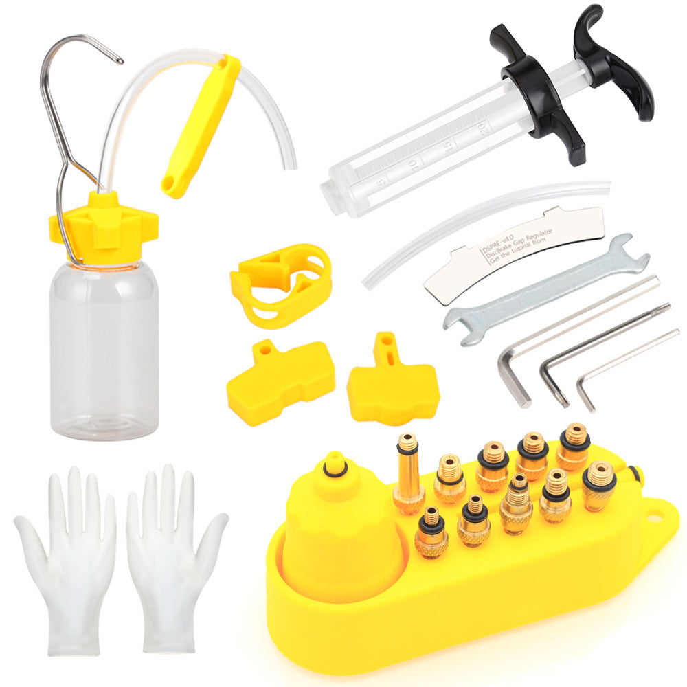 Bicycle disc brake fluid replacement kit including a bottle, nozzles, and accessories on a white background.