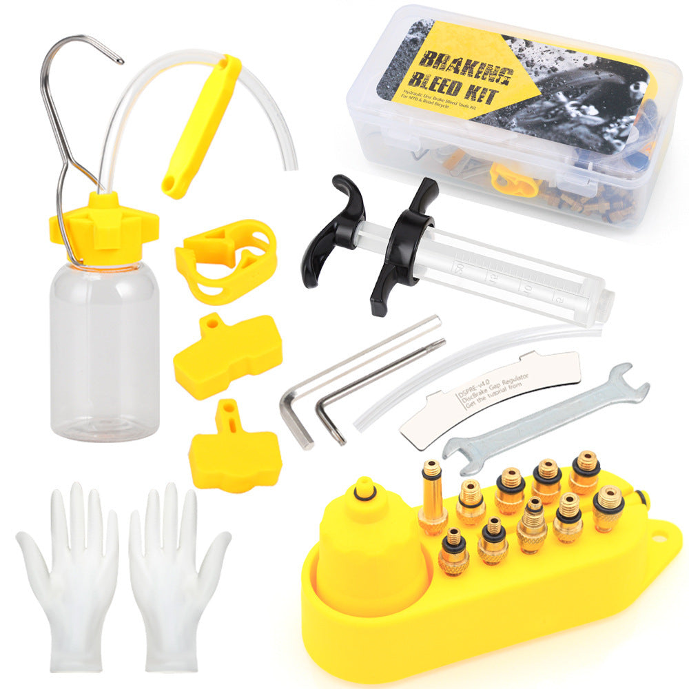 Bicycle disc brake bleed kit with various tools and components on a white background