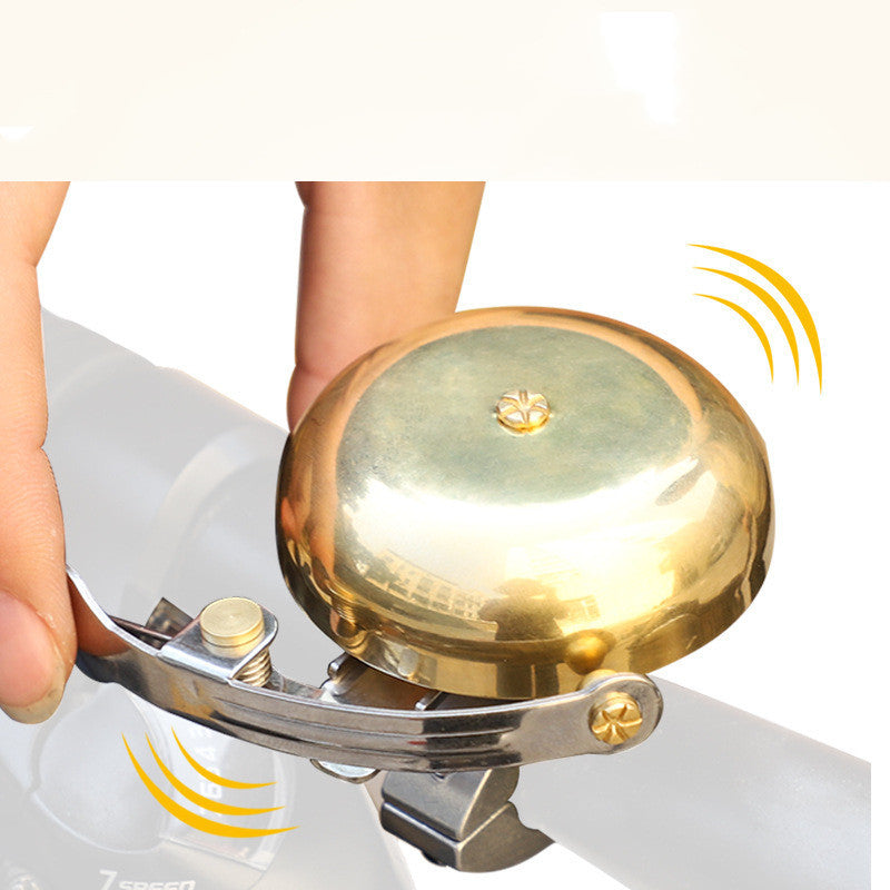 Gold Vintage-Style Bicycle Bell held by a hand with a white background