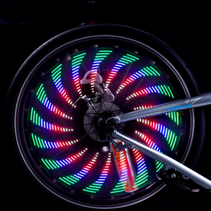 Bicycle wheel with colorful LED lights on a black background
