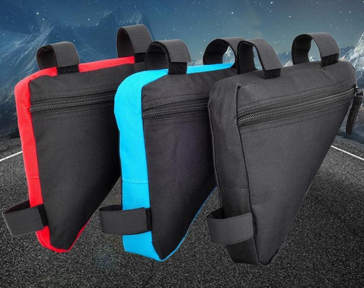 Three Waterproof Bicycle Framebags in black, blue, and red on a road with a mountain background.
