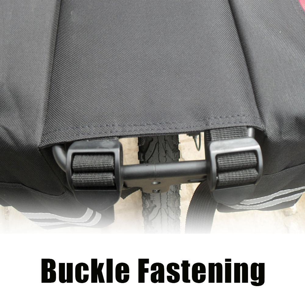 Close-up of a buckle fastening mechanism on a black bicycle pannier.