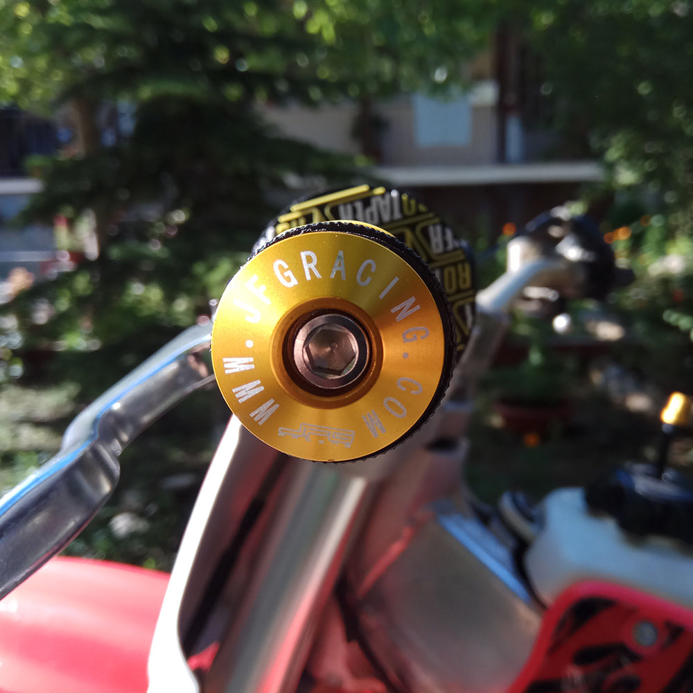 Close-up of a yellow aluminium bicycle handlebar grip with  branding, blurred background